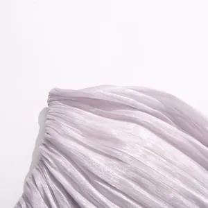 Close-up of light purple pleated fabric with subtle shimmer for elegant summer dress