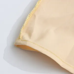 Detailed close-up showing the high-quality hemline and stitching on a yellow dress