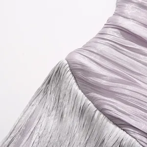 Macro view of lavender pleated fabric and elegant fringe details on the party dress
