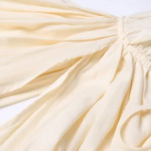 Vue détaillée du tissu plissé crème avec des détails de coutures froncées élégants