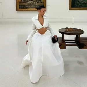 Elegant white two-piece set featuring V-neck cropped top and voluminous full skirt