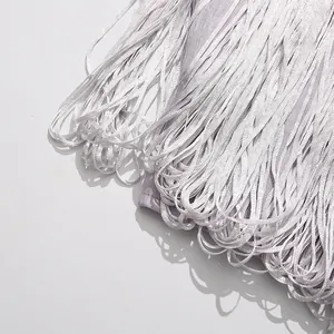Close-up macro detail showing the elegant high-density silver fringe on a party dress.
