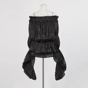 Back view of black off-the-shoulder ruffle dress with dramatic trailing ribbons