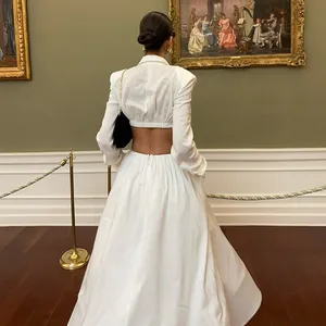 Back view of an elegant white two-piece set with a cropped top and long maxi skirt