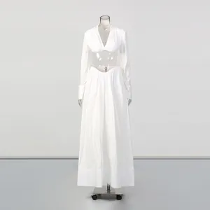 Elegant white two-piece set featuring a V-neck cropped top and matching long maxi skirt
