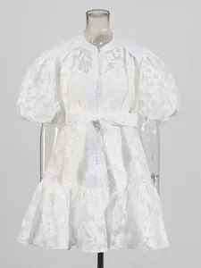 Elegant white hollow-out lace mini dress featuring chic puff sleeves and a belted waistline