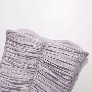 Close-up detail of invisible zipper on lavender pleated fabric of fashion party dress