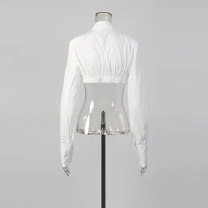 Detailed back view of a white cropped long-sleeved top on a transparent mannequin.