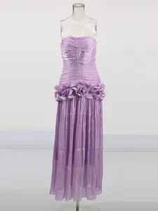 Elegant lavender strapless maxi dress featuring a ruffle waist and unique pleated design