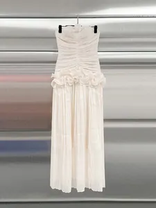 Elegant cream strapless maxi dress with ruffled waistline and pleated skirt details
