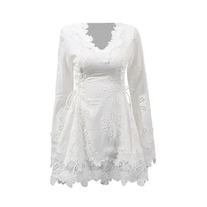 Detalle del vestido corto de encaje blanco vintage con motivos florales calados