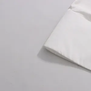 Close-up detail showing the soft white fabric texture of this elegant skirt and top set