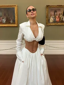 Elegant white two-piece clothing set with V-neck crop top and matching long skirt