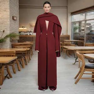 Full-length view of a burgundy cape-style coat with deep V-neck and cinched waist