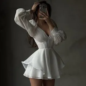 Close-up detail of white mesh long-sleeved V-neck mini dress with corset waist design