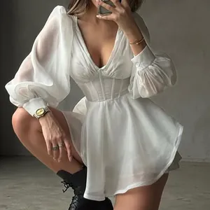Macro view of white mesh long sleeve dress featuring corset boning and V-neckline details