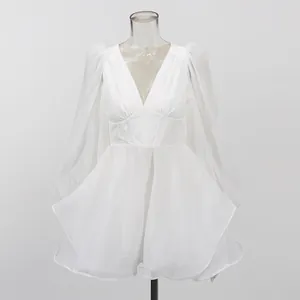 Front detailed view of a white mesh dress with V-neck and corset waist on a mannequin