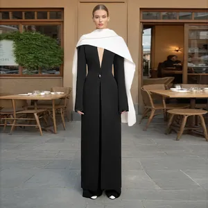 Elegant black long coat with white shawl collar and V-neck for a slim silhouette.