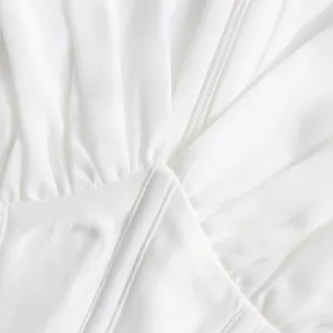 Detailed view of white mesh dress bodice showing corset-style fishbone waist and pleats