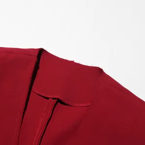 Close-up of wine red long coat neckline showing raw edge detail and fabric texture