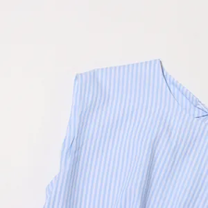 Macro detail showing blue and white vertical striped fabric of a French style dress