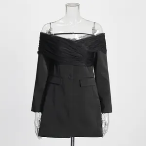 Detalle de costuras de malla y diseño de hombros descubiertos del vestido blazer negro
