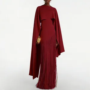 Detail of burgundy evening gown featuring cape shawl design and long fringe skirt hem