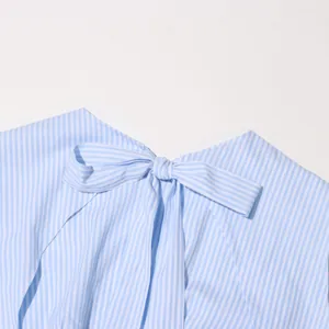 Close-up detail of a blue and white striped dress featuring a stylish back bow tie.