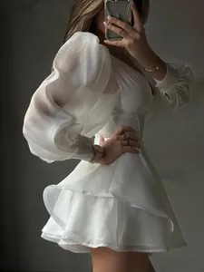 Elegant white organza puff sleeve mini dress with boned corset waist and tiered skirt.