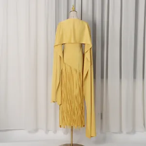 Detailed back view of a yellow designer cape dress featuring a long fringe skirt.