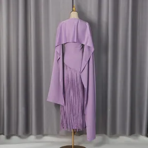 Back view detail of a purple evening dress featuring an integrated cape and fringe hem.