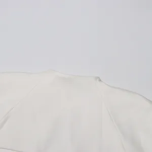 Detailopname van de hoogwaardige witte getextureerde stof van een elegante Franse jurk.