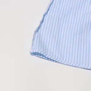 Detail of blue and white striped fabric featuring a stylish frayed hem design