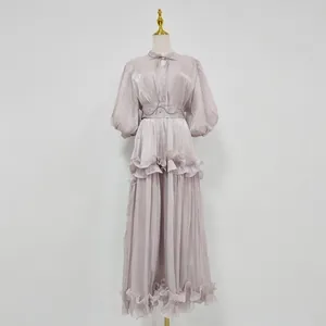 Elegant lilac puff sleeve maxi dress with ruffled hem and waist detail on a mannequin