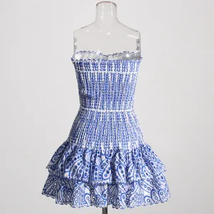 Front view of a blue and white hollow-out embroidery strapless tiered mini dress