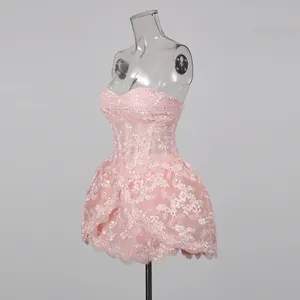 Side view of pink lace embroidered strapless mini dress on clear mannequin