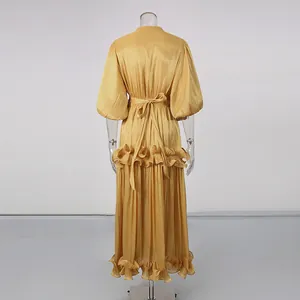 Detailed back view of an elegant gold puff sleeve maxi dress featuring a tiered ruffle hem