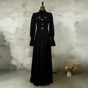 Close-up of French vintage black maxi dress with puff sleeves and embroidery details