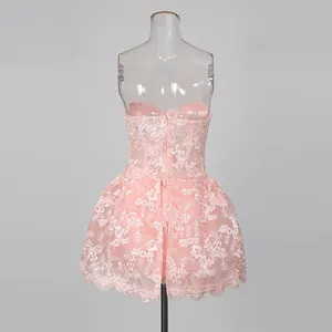 Back view of a pink lace embroidered strapless dress with invisible zipper detail.