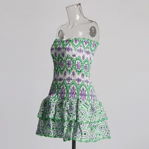 Detail view of white strapless dress with intricate green and purple floral embroidery