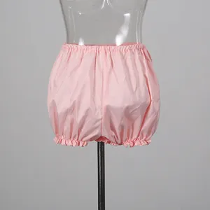 Detailed view of light pink ruffled bloomer shorts displayed on a transparent mannequin stand