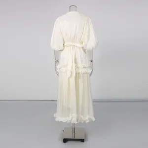 Detailed back view of an elegant white French maxi dress with puff sleeves and ruffles