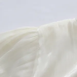Detailed view of white puff sleeve fabric and stitching on an elegant French dress