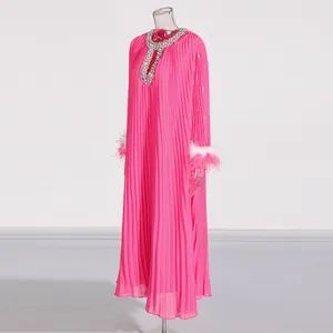 Elegant pink pleated maxi dress featuring rhinestone neckline and ostrich feather cuffs