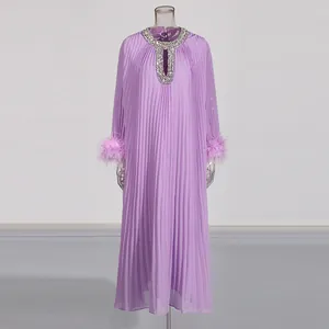 Elegant purple pleated maxi dress featuring rhinestone neckline and feather trim