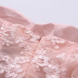 Close-up of pink floral lace embroidery and hidden zipper on a tube top dress detail