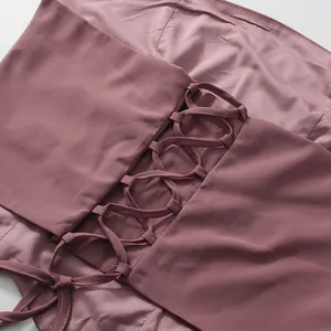 Close-up of elegant lace-up back detail on a dusty rose French court style dress