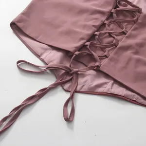 Close-up of the elegant lace-up corset detail on the back of a mauve French style dress