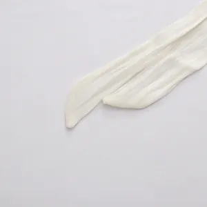 Detailed macro view of a white elegant dress sash tie with soft vertical texture