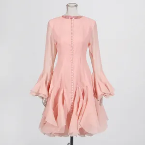 Elegante roze jurk in Franse stijl met ruches aan de zoom en modieuze klokmouwen